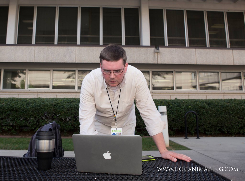 Photographer Jennifer Hogan captures me in the midst of checking in on social media and other news on Thursday, Oct. 9.