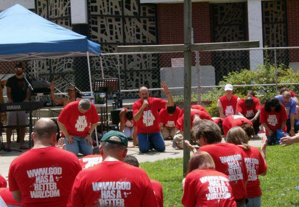 Lou Engle, kneeling with microphone, with Michael Brown kneeling to his right, at a 2009 rally outside an LGBT Pride event in Charlotte, N.C.