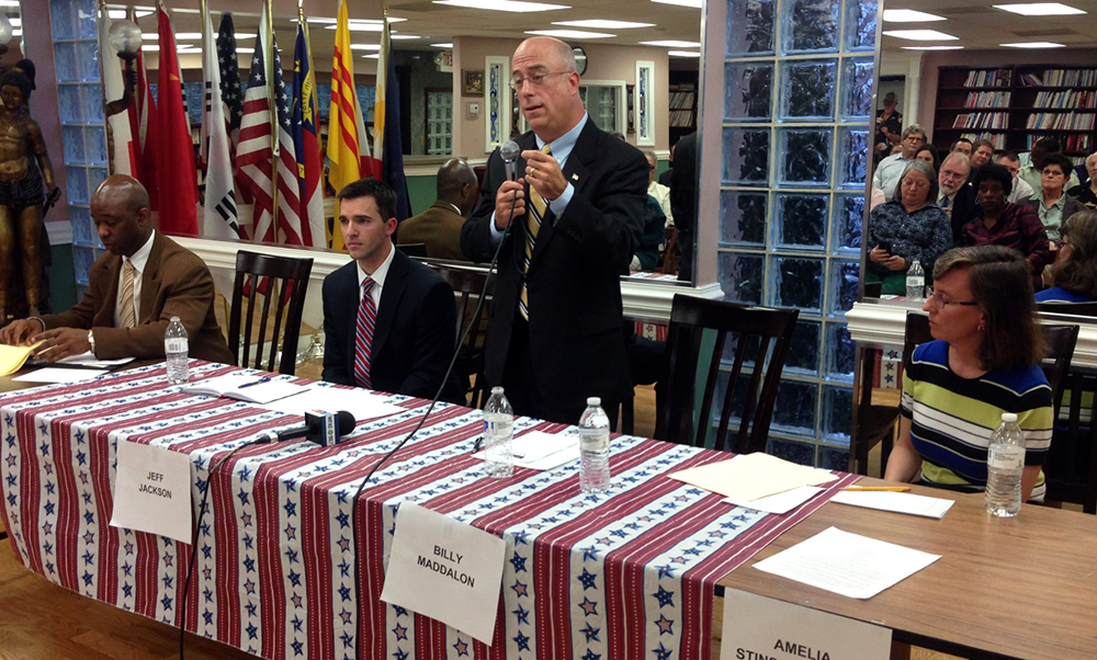 Billy Maddalon (standing) speaks at an April 2014 forum with three other candidates vying for a vacant state Senate seat (L-R): Darrell Bonaparte, Jeff Jackson and Amelia Stinson-Wesley. Photo by Matt Comer.